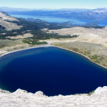 The crater lake of the Volcan Batea Mahuida with Lago Alumine in the background